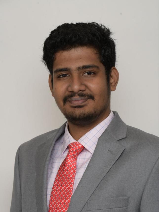 Portrait of Ashwin Sundararajan in a grey suit